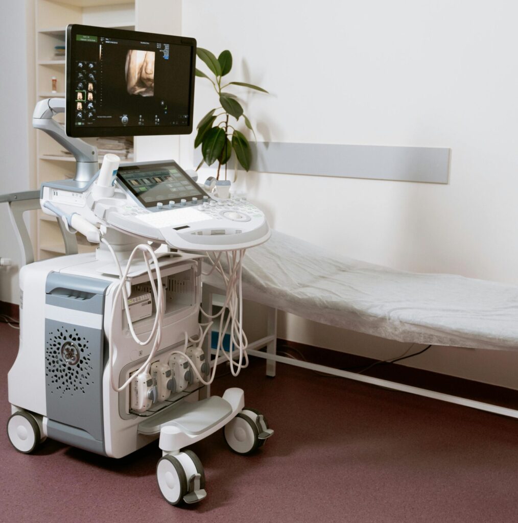 Ultrasound machine setup in a clinic room, ready for patient examination.